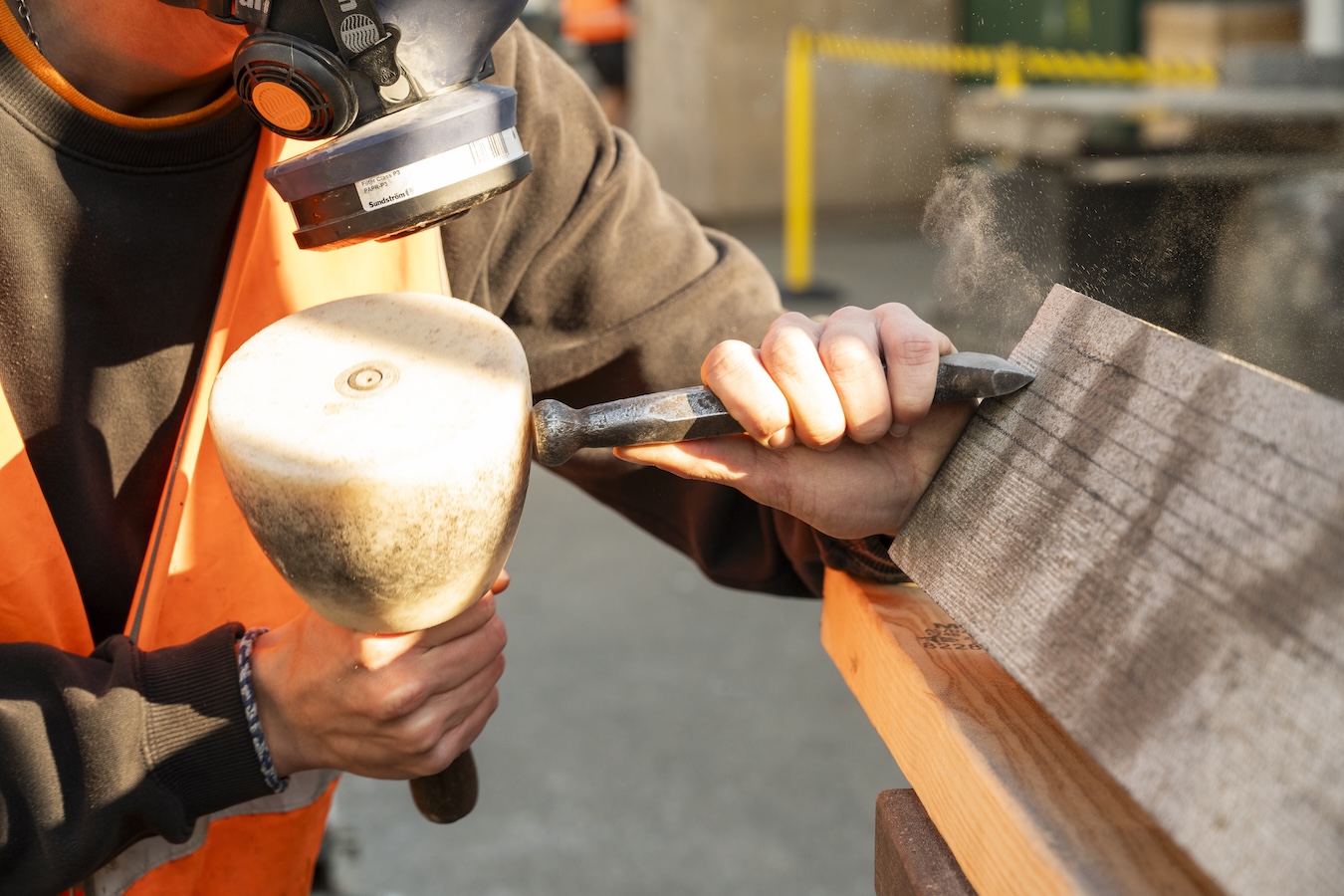 Stonemason shaping stone during restoration work on Princes Bridge