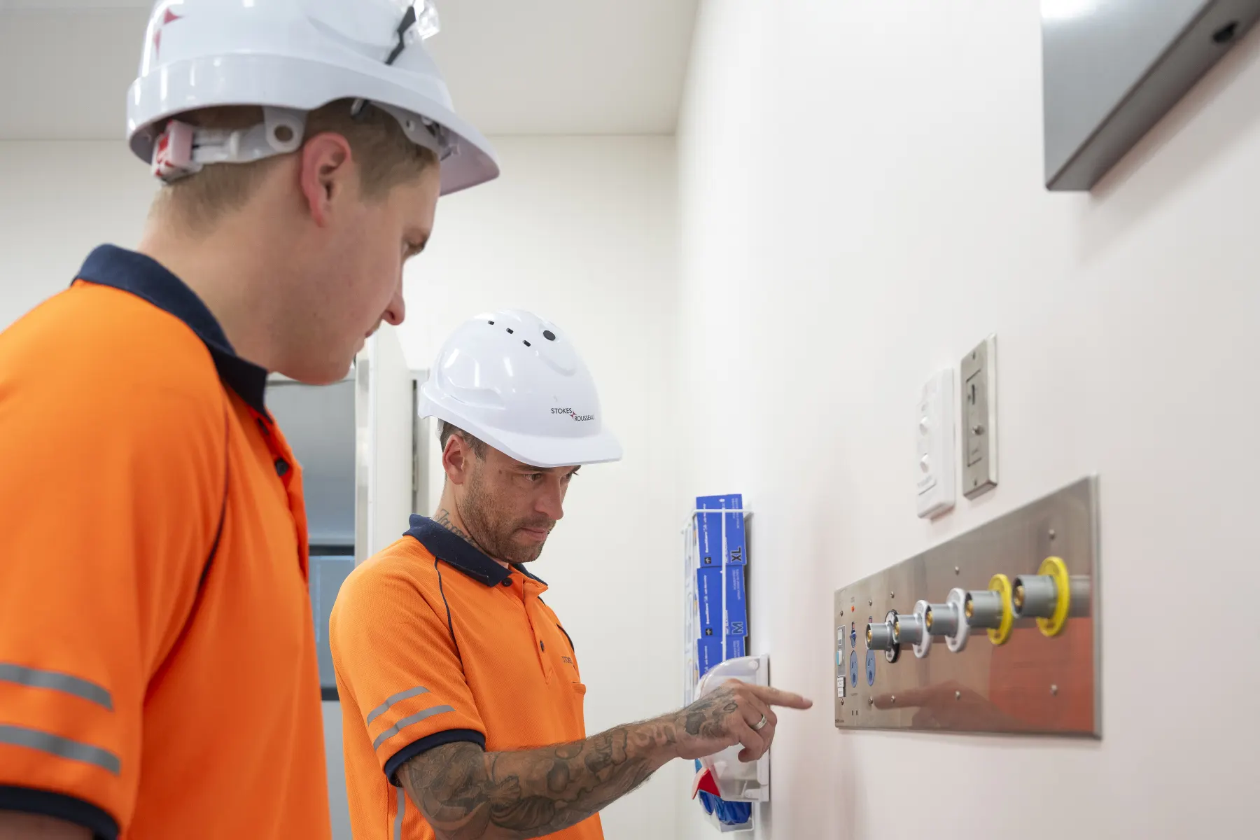 Stokes team members checking building services on site